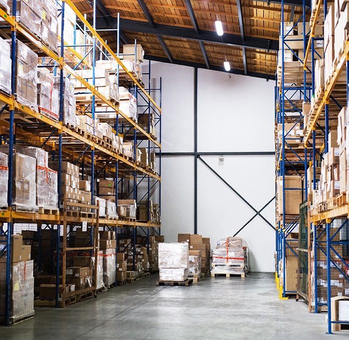 Warehouse requiring AI price optimization with shelves full of wholesale goods ready for distribution